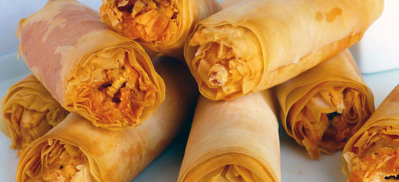 Close-up of crispy, golden brown spring rolls.