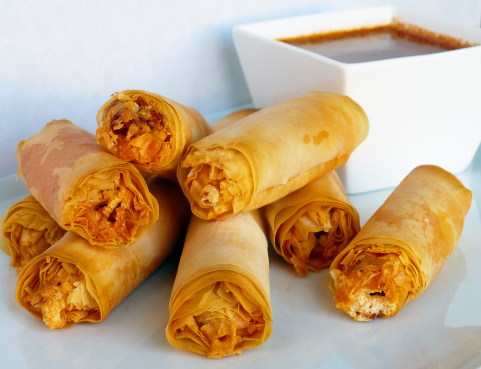 Crispy spring rolls filled with shredded vegetables, served with a dipping sauce.