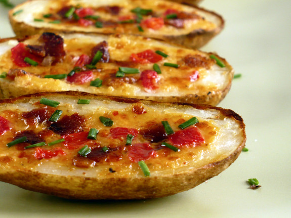 Crispy potato skins loaded with cheese, bacon, and herbs.