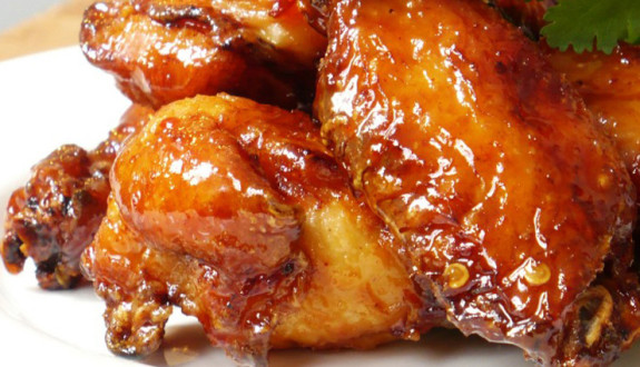Close-up of glazed, crispy chicken wings.