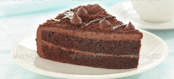 A slice of rich chocolate cake with creamy frosting.