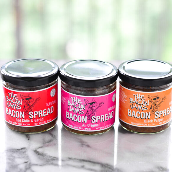 Three jars of assorted bacon spread.