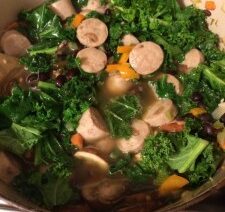 Kale and sausage stew with vegetables.