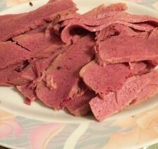 Sliced corned beef on a decorative plate.