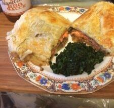 Pastry dish with greens on decorative plate.