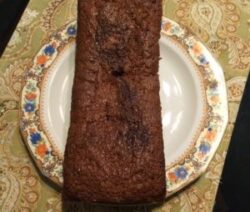 Loaf of bread on decorative plate.