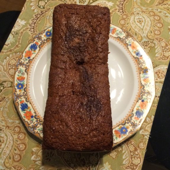 A rectangular chocolate cake on a decorative plate.