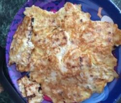 Scrambled eggs on a decorative plate.