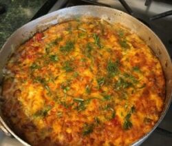 Baked dish with herbs in a pan.