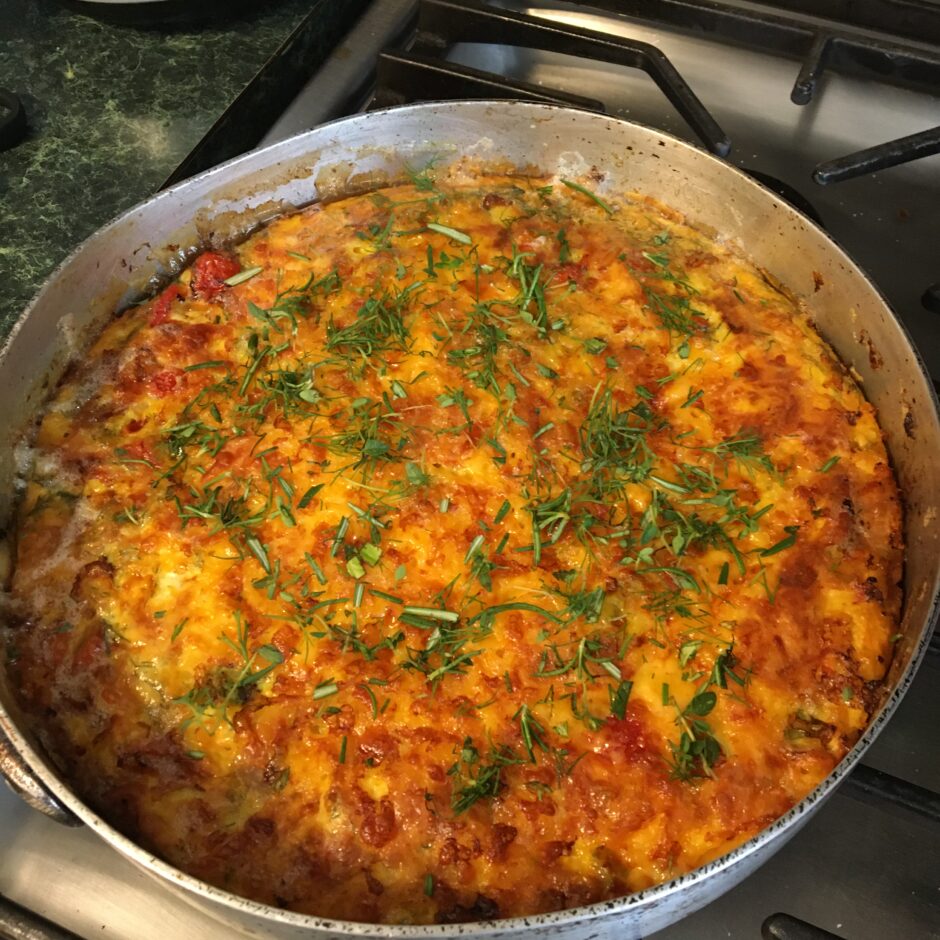 A savory chicken baked dish with tomatoes and herbs in a pan.