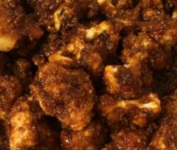 Spicy fried cauliflower bites with sauce.