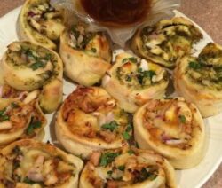 Savory pastry rolls with dipping sauce.
