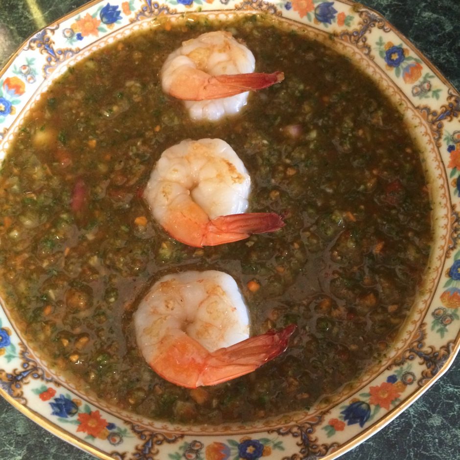 Shrimp-topped lentil soup served in a decorative bowl.