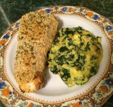 Breaded fish and spinach mashed potatoes plate.
