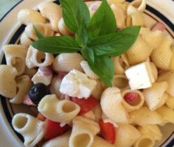 Pasta salad with basil and feta cheese.