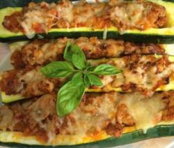 Stuffed zucchini boats with cheese and basil.