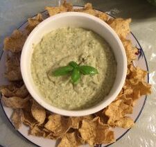 Bowl of dip with tortilla chips.