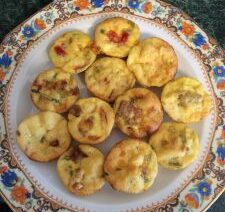 Mini quiches on decorative floral plate.