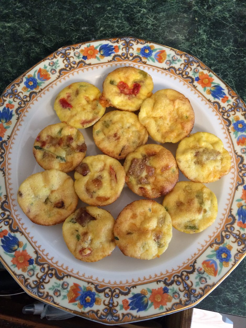 Plate of homemade mini egg muffins with vegetables.