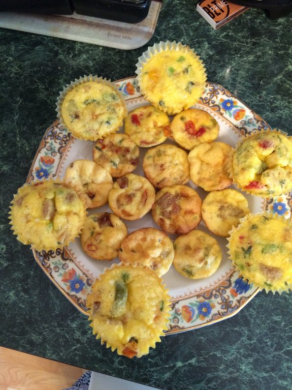 A plate of assorted mini tarts and flower-shaped pastries.