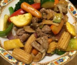 Stir-fried vegetables and meat on plate.