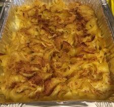 Baked noodle casserole in aluminum tray.