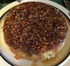 Pecan-topped cake on a decorative plate.