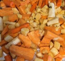 Chopped root vegetables on foil sheet.