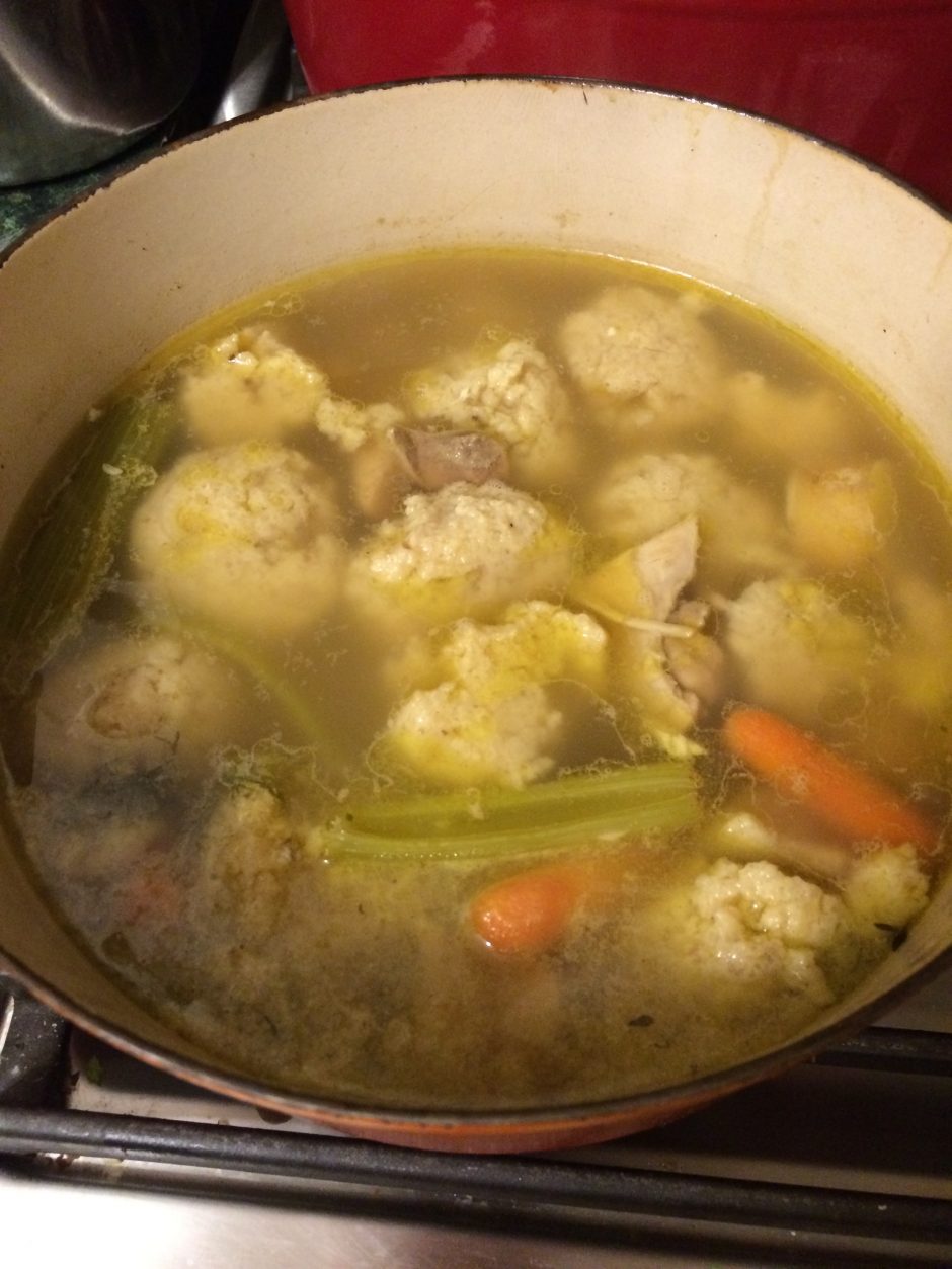 A pot of homemade chicken and vegetable soup with dumplings.