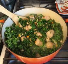Pot of stew with vegetables and meatballs.