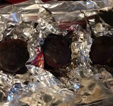 Roasted beets wrapped in aluminum foil.