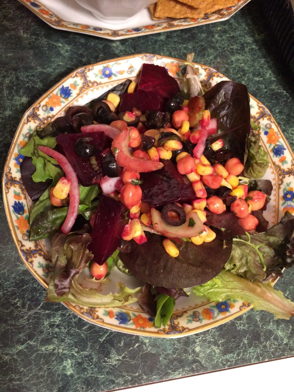 Colorful salad with beets, corn, and leafy greens.