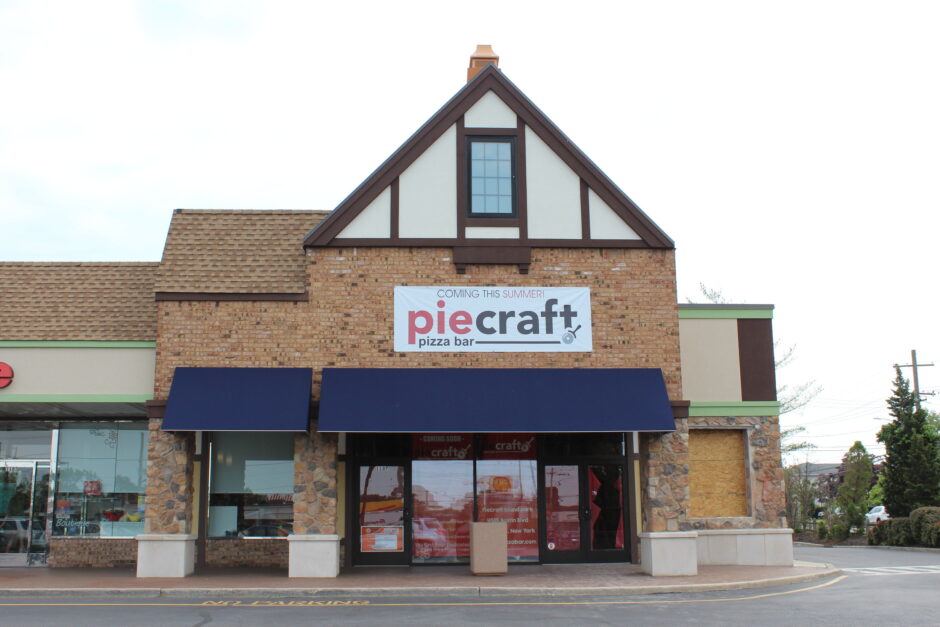 Brick building with "Piecraft" pizza bar sign.