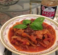 Bowl of stew with basil garnish.