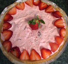 Strawberry pie with sliced strawberries on top.