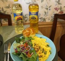 Omelette and salad with cooking oil displayed.
