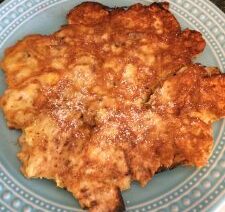 Golden brown fritter on a blue plate.