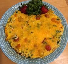 Cheese omelette with strawberries and parsley garnish.