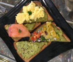 Assorted avocado toasts with various toppings.