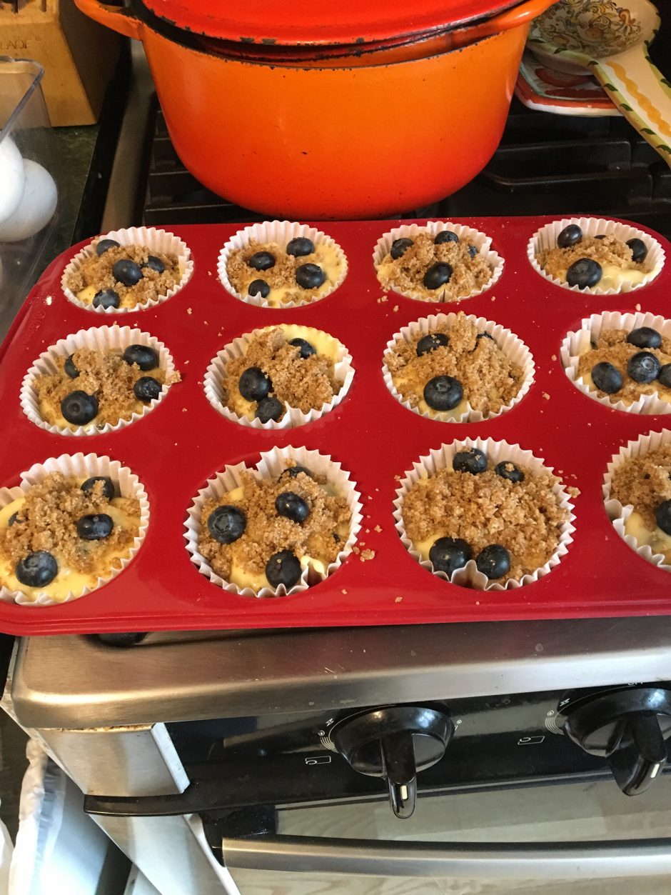 Unbaked blueberry muffins in a red silicone muffin tray.