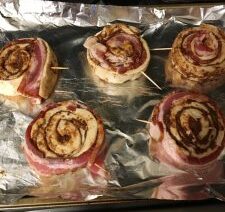 Bacon-wrapped cinnamon rolls on baking sheet.