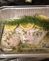 Raw chicken with lemon and rosemary seasoning.