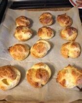 Golden brown buns on a baking tray.