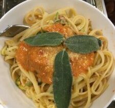 Pasta with tomato sauce and sage leaves.