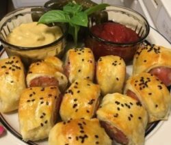 Pigs in blankets with mustard and ketchup.