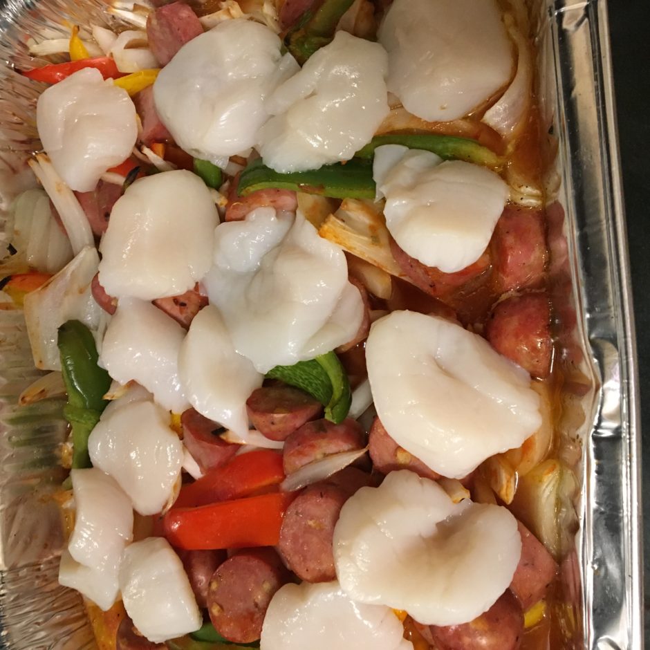 Close-up of a homemade pizza with fresh mozzarella and vegetables.
