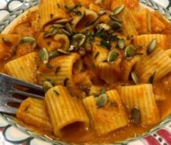 Pasta with pumpkin sauce and seeds.