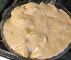 Unbaked pie with creamy filling in dish.