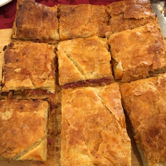 Golden-brown baked pastry squares with flaky crusts.