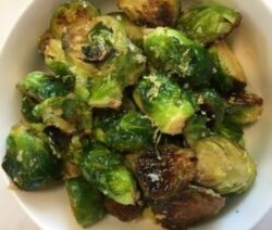 Roasted Brussels sprouts in a white bowl.